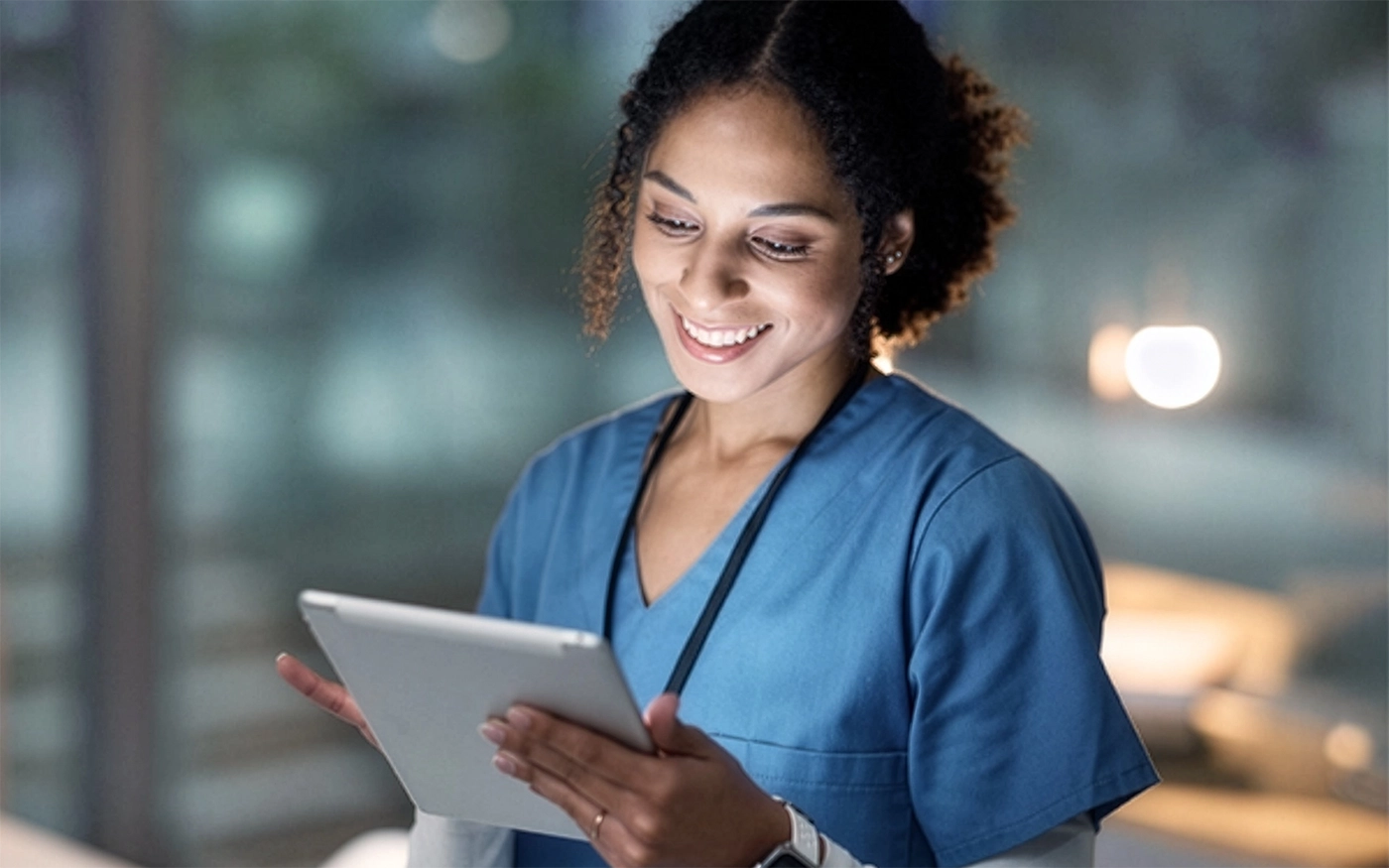 Female medical person holding an electronic tablet.