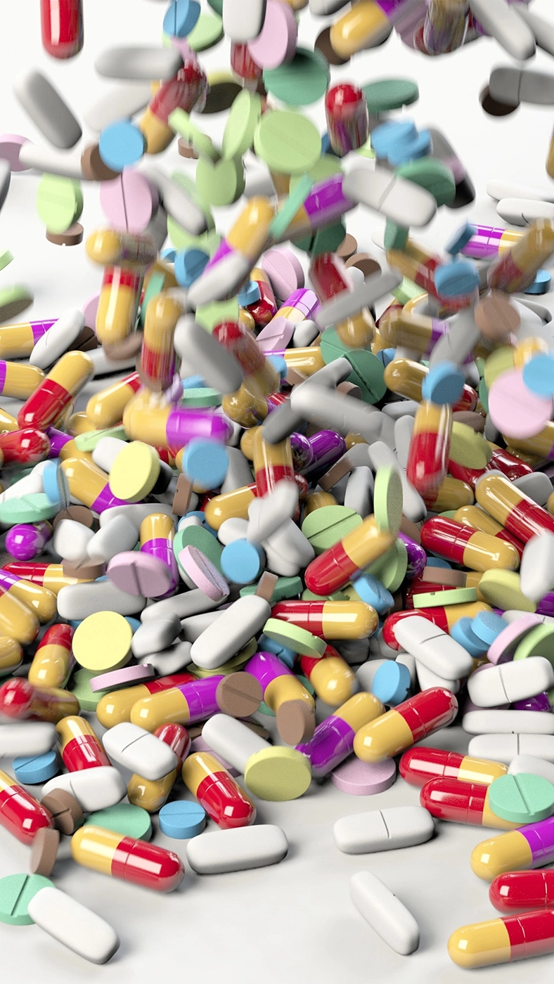 Cascade of multi-colored pills, capsules, and tablets.